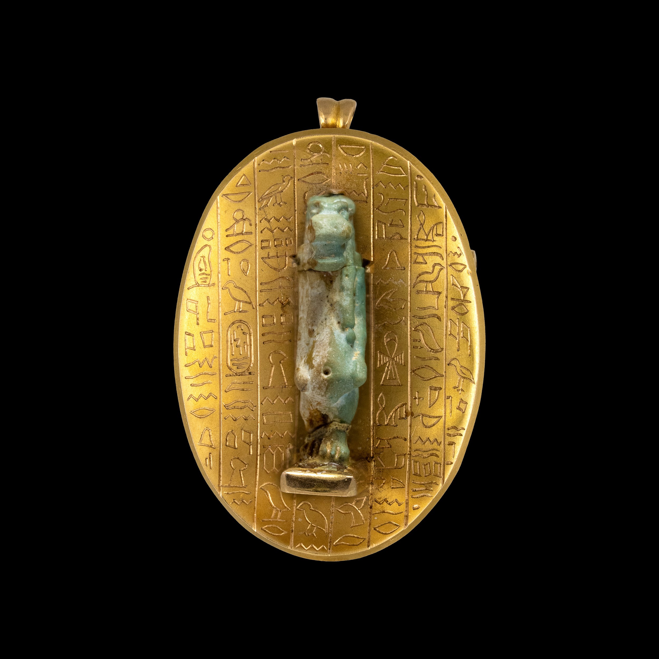 A Late 19th c. Egyptian Revival gold pendant with a Late Period faience amulet of Taweret. 